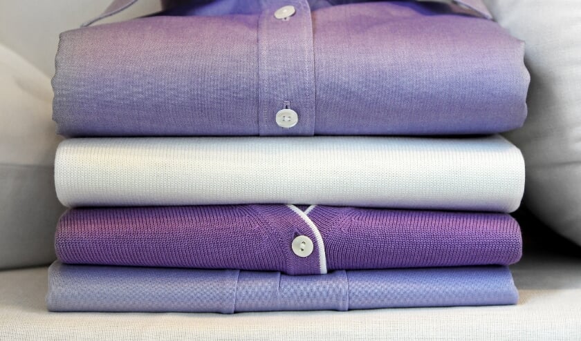 Formal purple shirt at pile of clothing