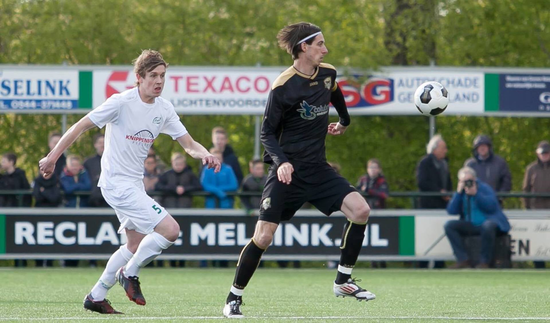  FC Winterswijk-aanvoerder Mike Leuijerink wil de bal onder controle brengen. Links RKZVC-speler Bas Heutinck. Foto: Marco ter Haar.
