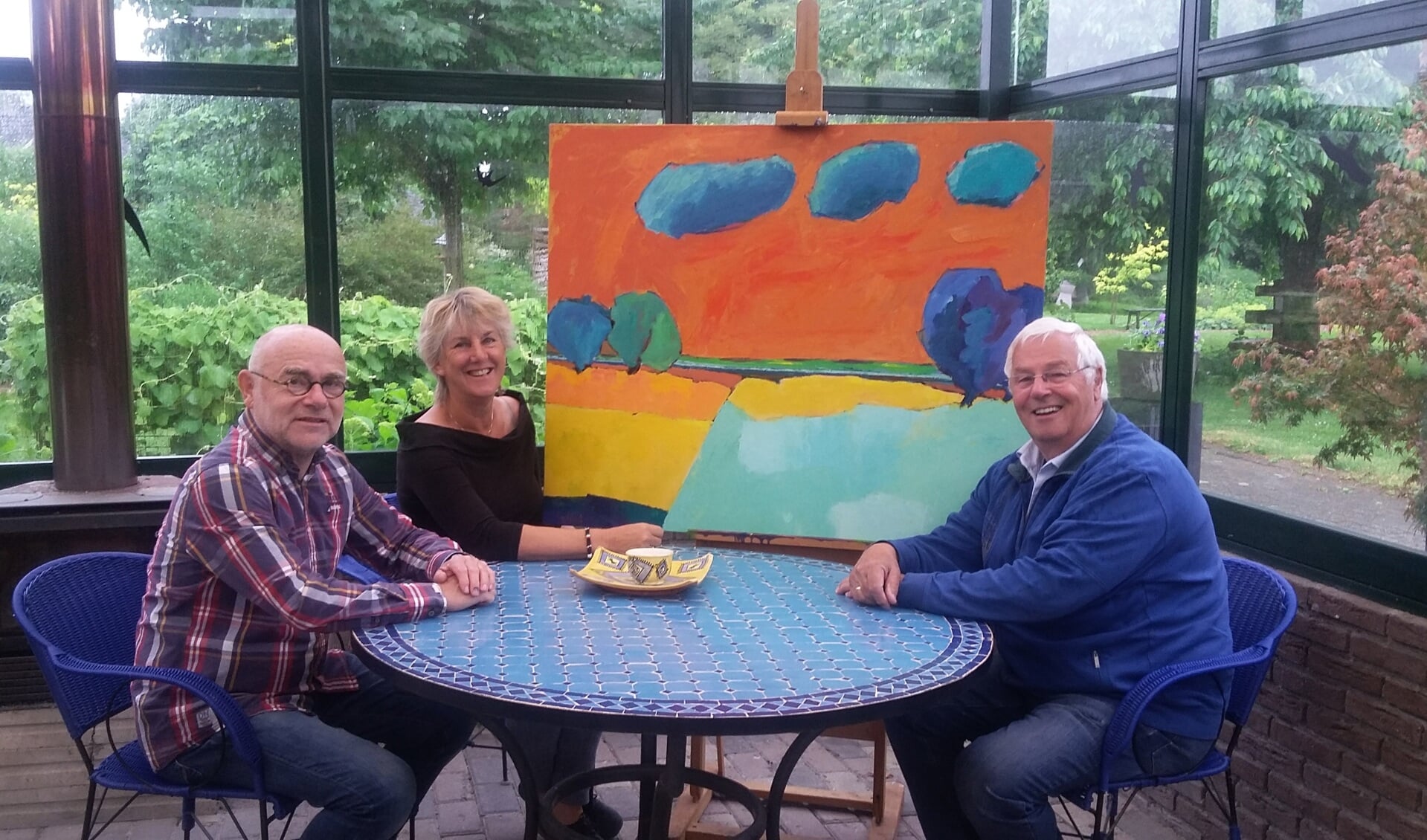 Jeannette Baart, eigenaresse van Ars Longa, en Henny Dokter (r)  met kunstenaar Henk Hulshof (l) en zijn werk 'De uiterwaarden van de IJssel'. Foto: Ceciel Bremer