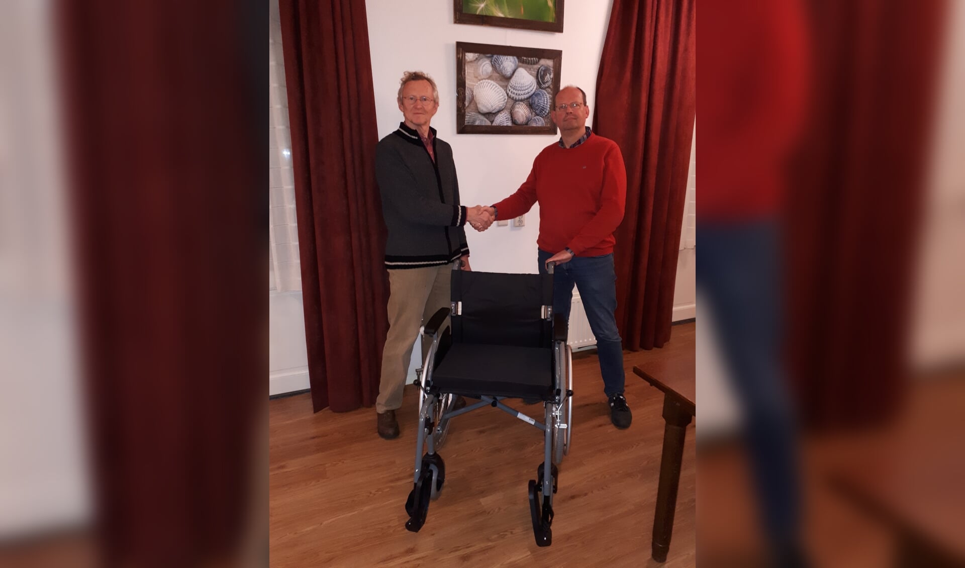 Eddy Brinkman (rechts) overhandigt namens de Barchemse Ondernemers Vereniging de nieuwe rolstoel aan Herman Morsink, voorzitter van de Stichting Vrienden Woonplus Barchem. Foto: PR. 