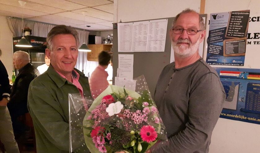 Henk Wassink (l.) krijgt van voorzitter Hans Menkhorst bloemen voor zijn eerste in de CC. Foto: Wim Wisselink