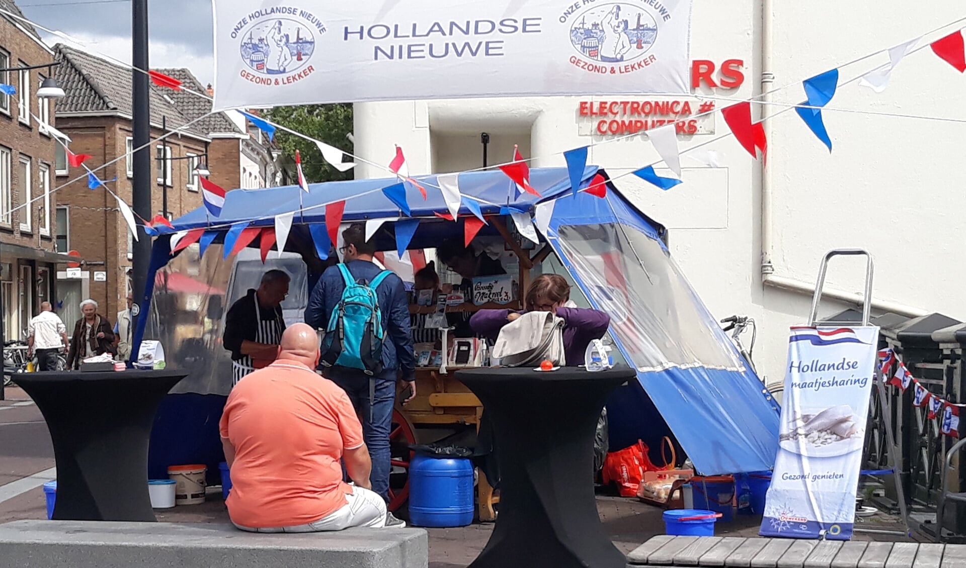 Hollandse nieuwe haring proeven bij de versierde haringkar van Hoekstra. Foto: PR