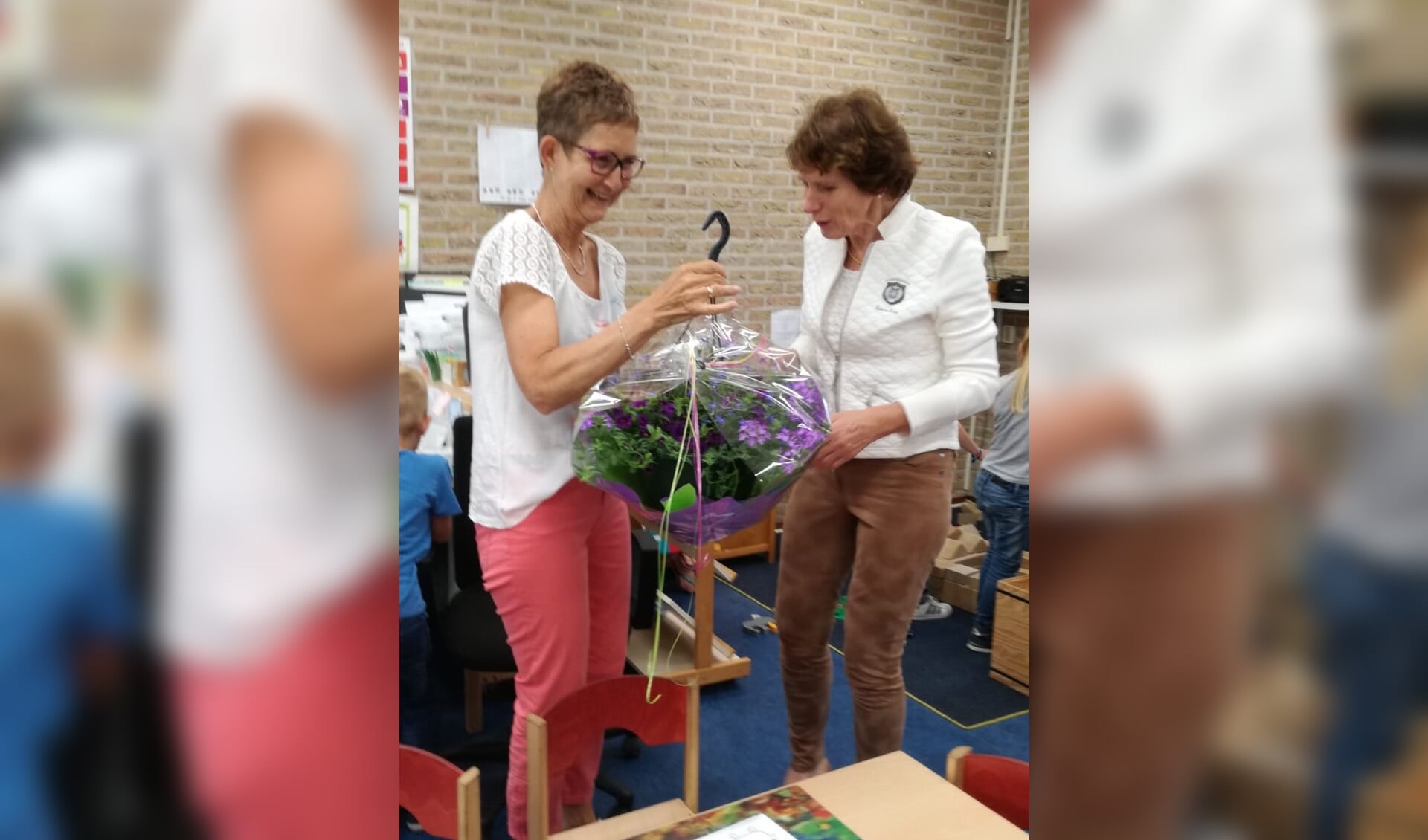 Anneke Beijk werd blij verrast met een prachtige tuinplant door locatiecoördinator Willemien van Uhm. Foto: PR 