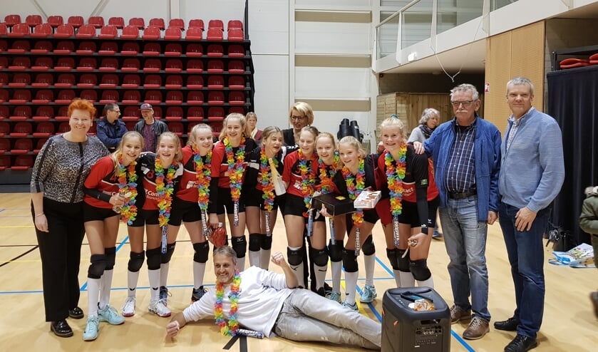 Dash MC1 met van links naar rechts: Femke, Merle, Guusje, Roos, Senna, Renate, Lotte, Irene en Silke, met bestuursleden Leo Kamphuis en Miriam Jansen en sponsoren Achterhoek Nieuws Nancy en Gerhard Weevers. Liggend: trotse coach Marco. Foto: Thea Valster