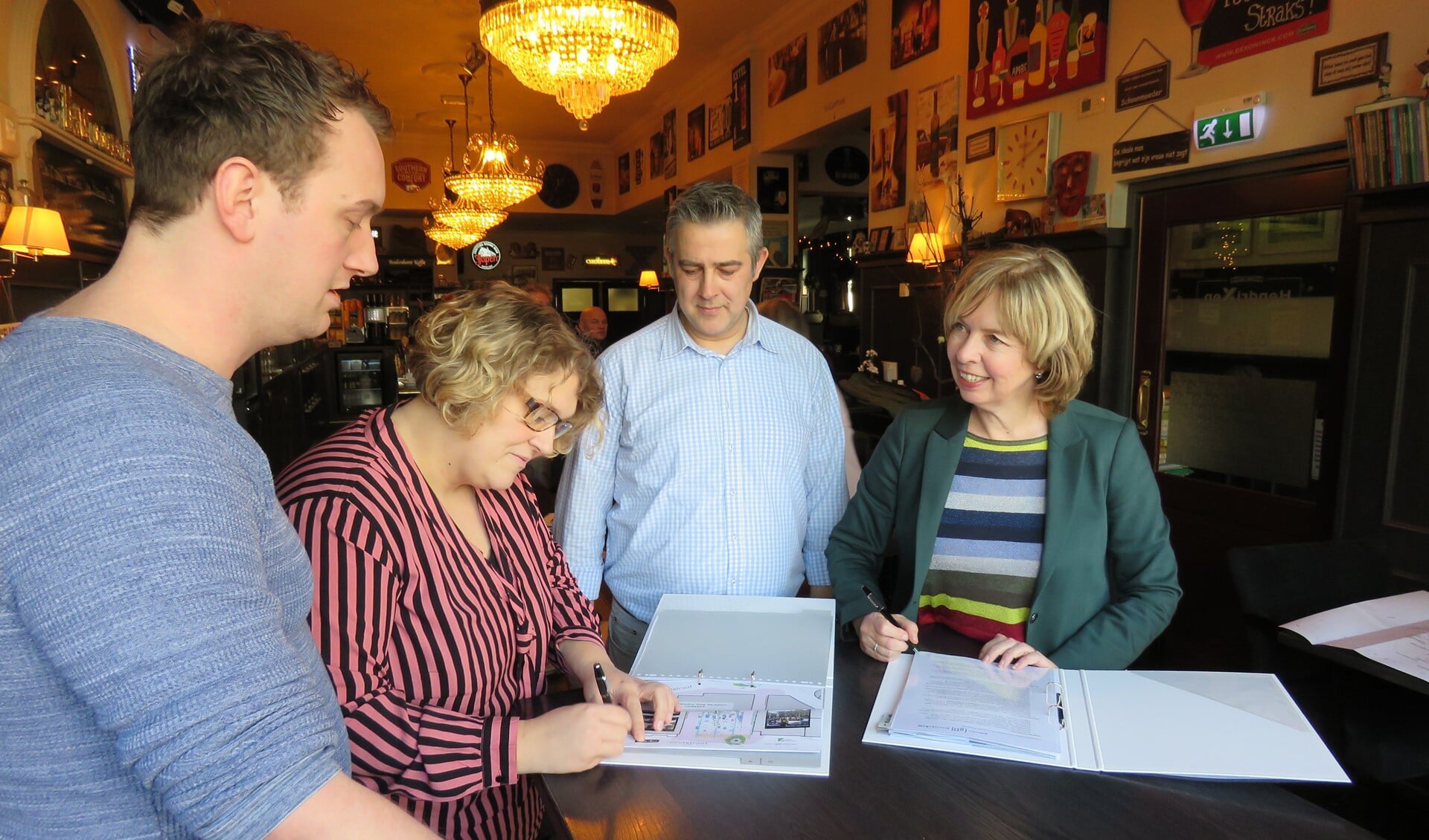 Christie Hendrixen tekent de overeenkomst, terwijl Rick Hendrixen, Nard Everdij en wethouder Ingrid Lambregts (vlnr)  toekijken. Foto: Bert Vinkenborg