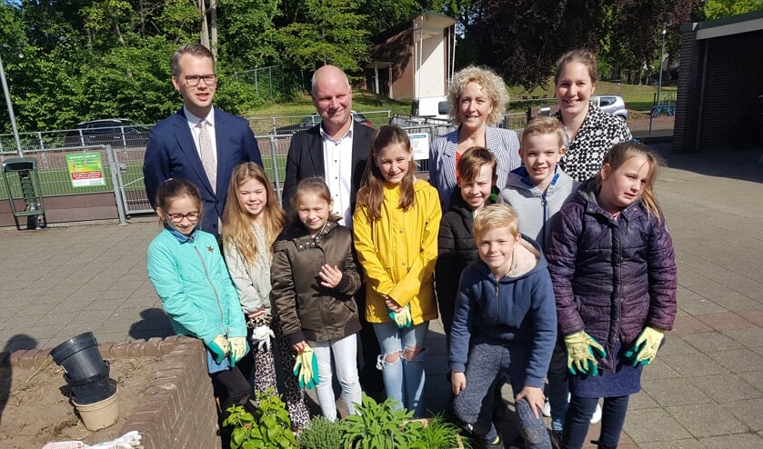 Het kruidentuintje van de Watermolenschool met op de achtergrond vlnr wethouder Bart Porskamp, Peter Schrijver van het Waterschap Rijn IJssel, Leontien Witjes van Staring Advies en juf Rosalie. Foto: Kyra Broshuis