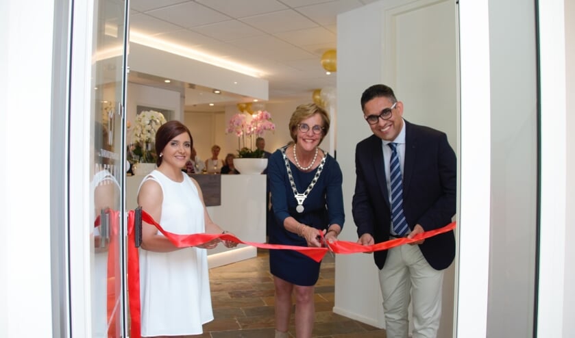 Burgemeester Bronsvoort opent in het bijzijn van Sepand Manouchehr (rechts) en Atefeh Kamalian de nieuwe Tandartspraktijk Bleekwal. Foto: Annekée Cuppers