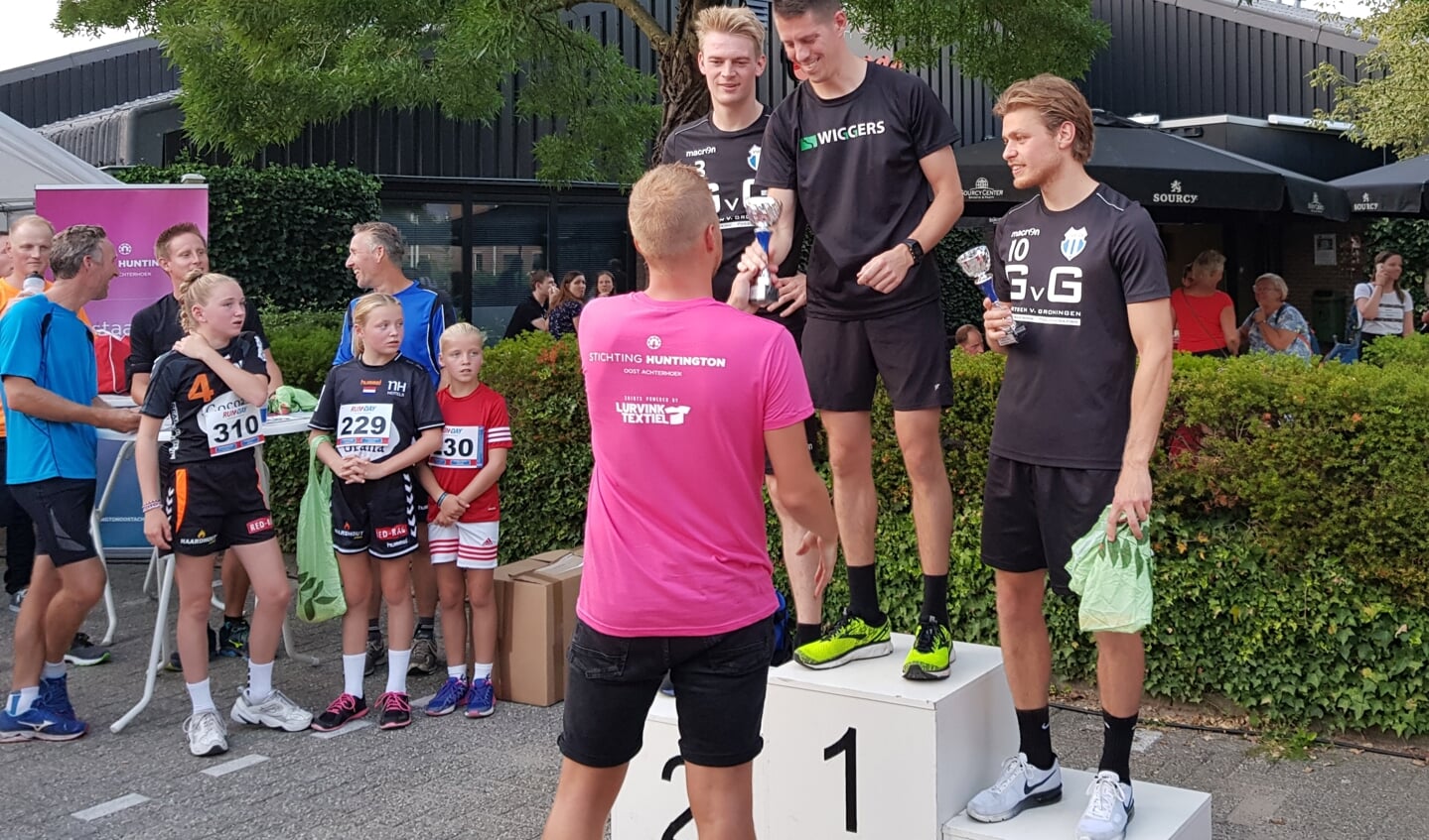 Michiel Krabbenborg reikt de prijzen uit aan de winnende deelnemers. Hier aan Thomas Konings, winnaar op de 10 km. Foto: Henri Walterbos
