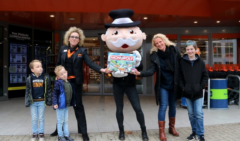 <p>Monique van der Voort van Coop Vorden (l) samen met Mr. Monopoly en Boukje te Meerman met de Vordense versie van het monopoly-spel. Foto: Rob Schmitz</p>