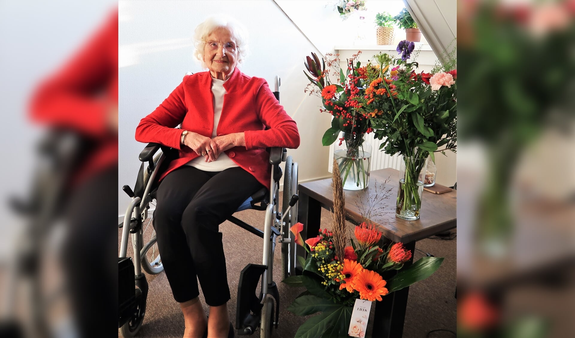 Riek Frielink-Haarhuis met een bloemenpracht in verband met haar 99ste verjaardag. Foto: Theo Huijskes