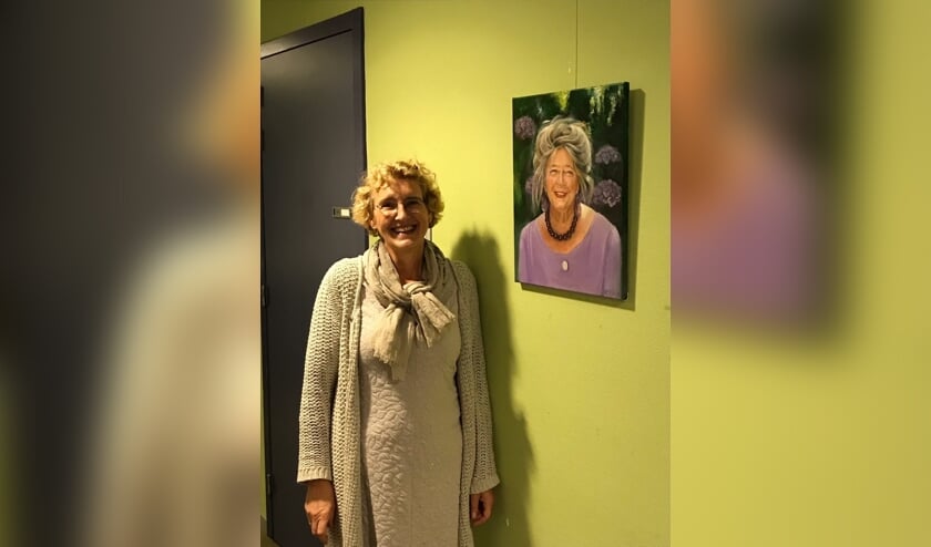 <p>Ellen de Zwart bij een van de door haar gemaakte portretten. Foto: PR</p>