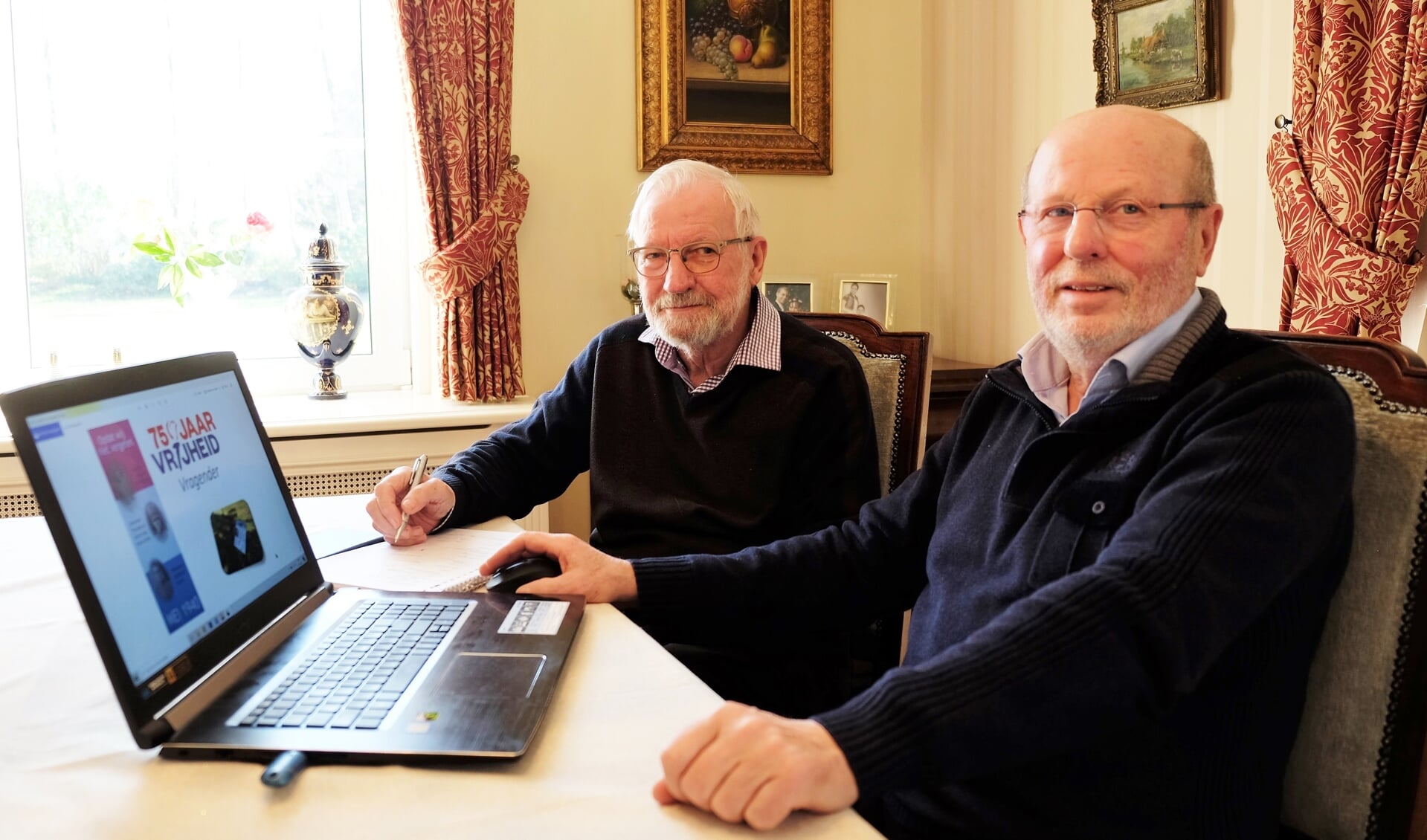 Wim Rutgers (links) en Hans Veldkamp, werkende aan hun zevende boek: ’75 jaar Vrijheid Vragender’.