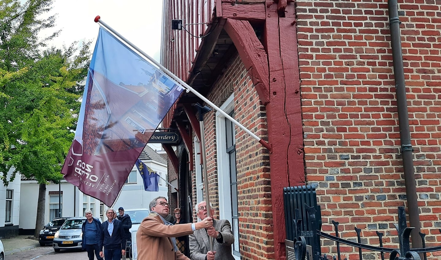 Wethouder Bart Porskamp hijst de vlag met het nieuwe beeldmerk bij de Stadsboerderij. Foto: Kyra Broshuis