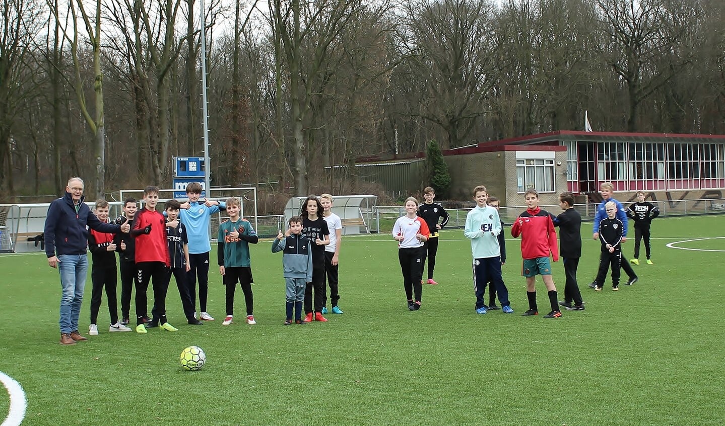 Toezichthouder John Teunissen met een aantal voetballende kinderen. Foto: Marlous Velthausz