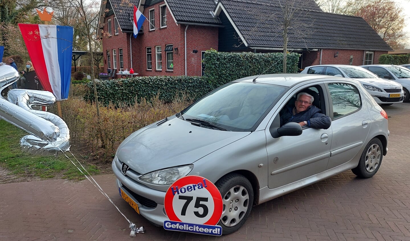 Jan Samberg geniet als 75-jarig lid van Crescendo van het defilé per auto. Foto: Han van de Laar