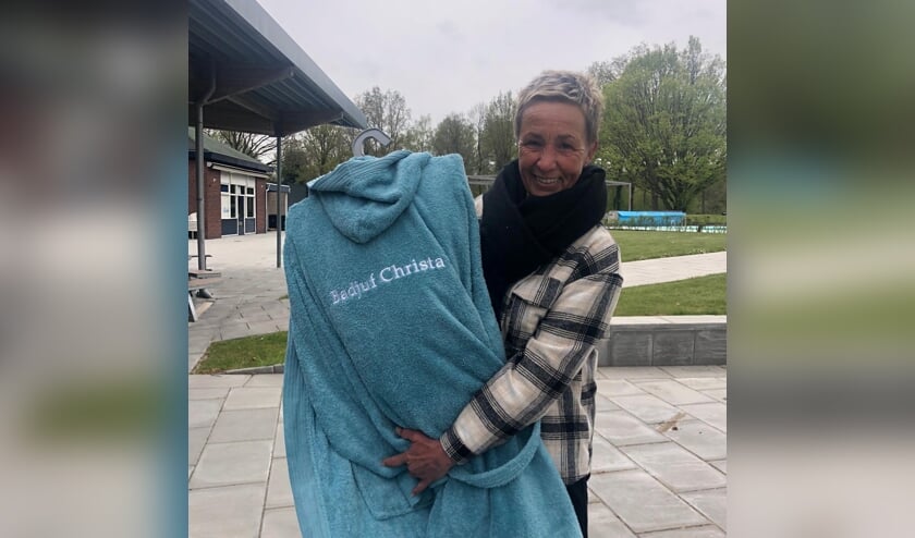 <p>Christa Meulenveld kreeg bloemen, diverse cadeautjes en een nieuwe badjas met de tekst ‘Badjuf Christa’. Foto: PR </p>