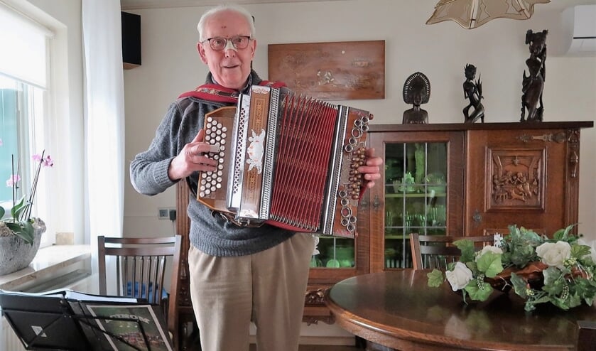 <p>Vrijwilliger Joop Vos, enigszins gehavend, spelend op zijn trekharmonica. Foto: Theo Huijskes</p>