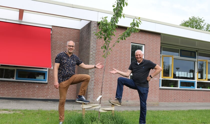 <p>Taco Houkema (l.) en Bertus Karssenberg bij één van de fruitbomen voor de Beatrixschool. Foto: Arjen Dieperink</p>