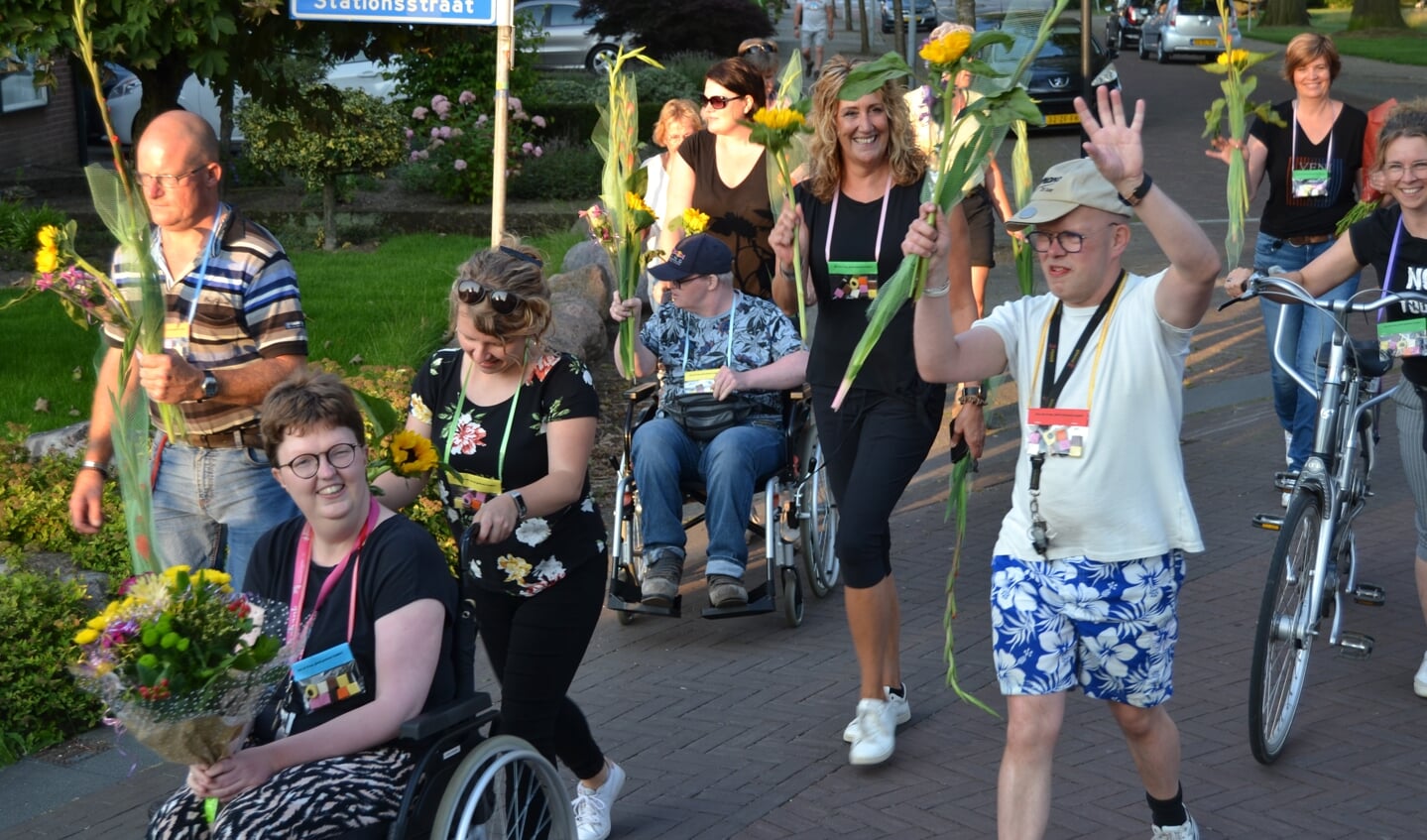 Cliënten van Estinea tijdens de 'alternatieve' Avond4daagse worden ingehaald met bloemen. Foto Karin Stronks