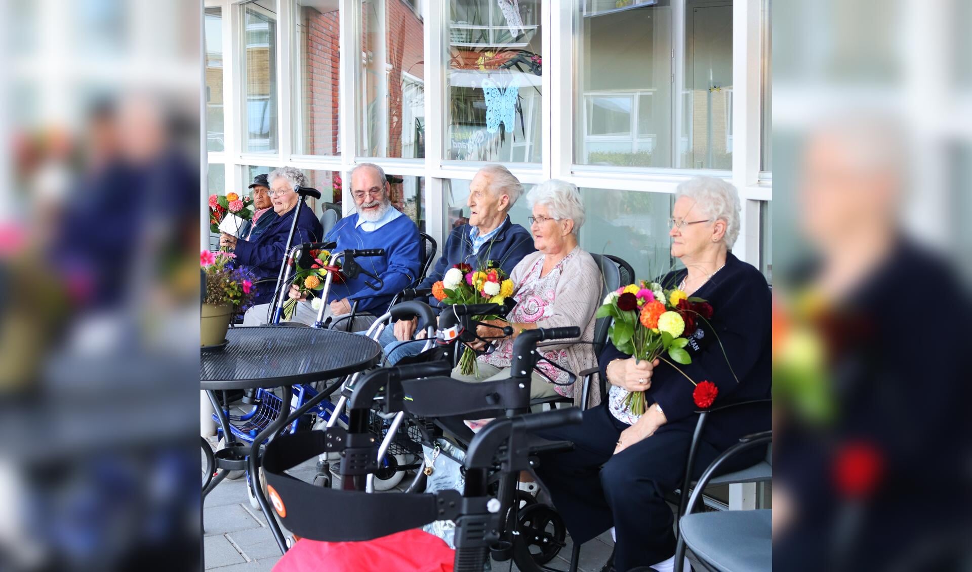De senioren werden verrast met dahlia's. Foto: PR