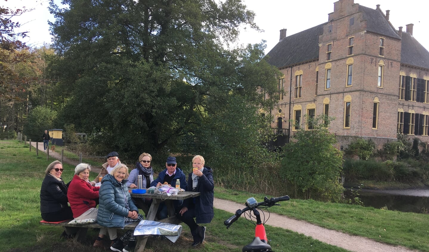 De 40 km fietsgroep van Marian probeert alle lunchmogelijkheden uit, hier maken de deelnemers gebruik van een bankje bij een kasteel. Foto: Stichting Gilde Zutphen