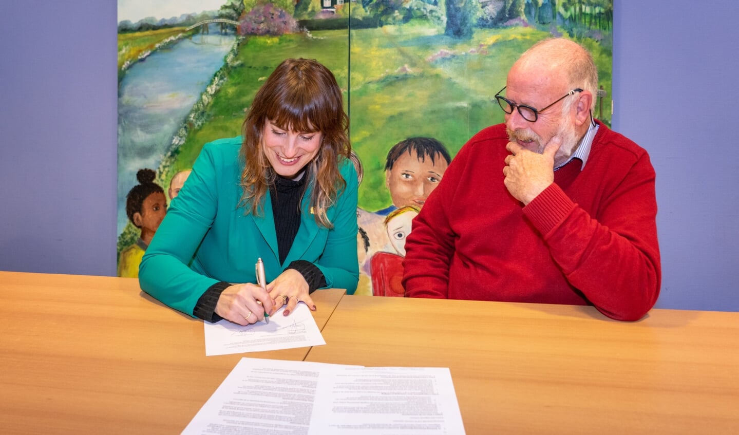 Wethouder Eva Boswinkel en Dorpsraad Warnsveld-voorzitter Cyp Wagenaar bezegelen de samenwerkingsovereenkomst. Foto: Jolanda van Velzen