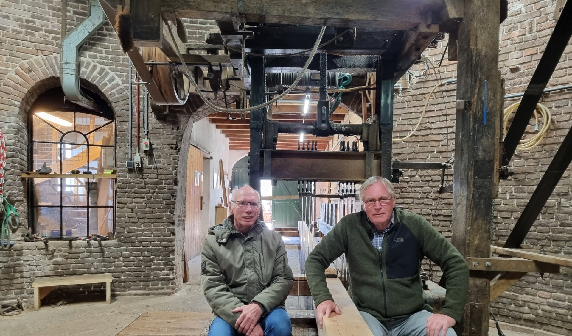 Vrijwillige molenaars Jelle Wierda (l) en Aart Wieringa op de zaagbak van molen Agneta. Foto: Rob Weeber