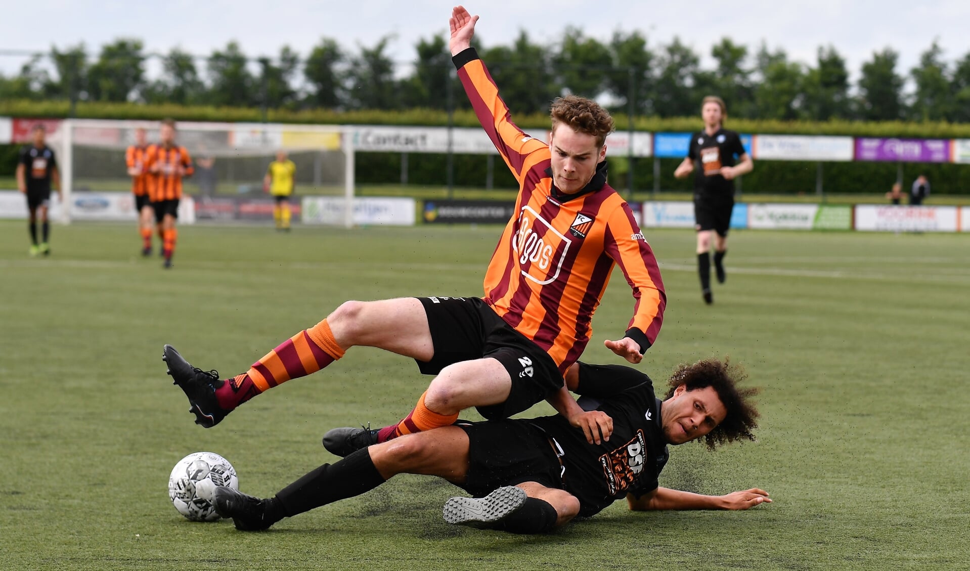 Het ging er fel aan toe in de wedstrijd FC Zutphen tegen ESA die in 3-3 eindigde. Hier wordt Timon Kuiper met een flinke sliding aangepakt. Foto: Hans ten Brinke