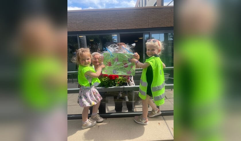Een bewoner van de Bleijke krijgt een mooie creatie van de kinderen. Foto: PR