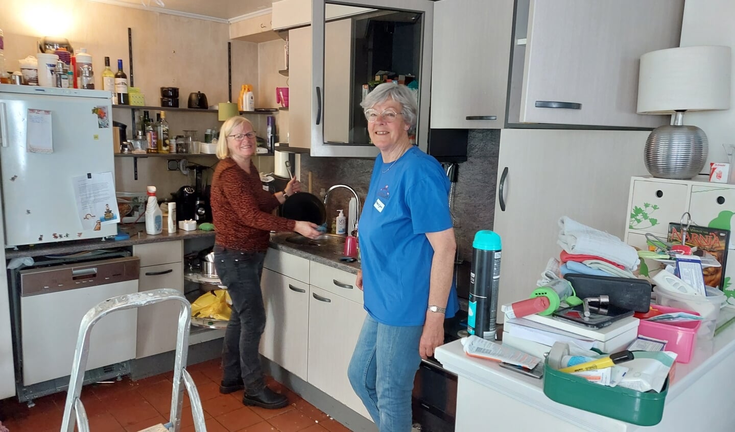 Twee vrijwilligers ruimen de keuken op. Foto: PR Present Winterswijk