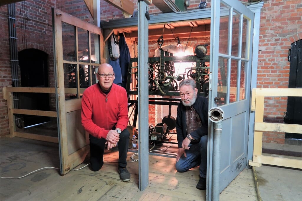 Laurens Kolkman (links) en André Papen bij het torenuurwerk in de Zieuwentse kerk. Foto: Theo Huijskes