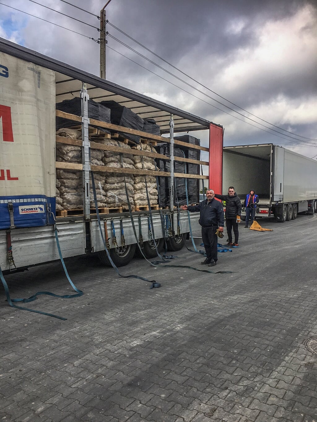 De spullen worden door Poolse chauffeurs overgeladen van de vrachtwagen van Gesink naar Angela. Foto: Aart Steenbergen