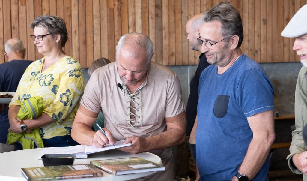 Arjen van Buuren signeert zijn boek. Veel mensen hebben eraan meegewerkt, onder wie de maker van deze foto. Foto: Patrick van Gemert/ Zutphens Persbureau