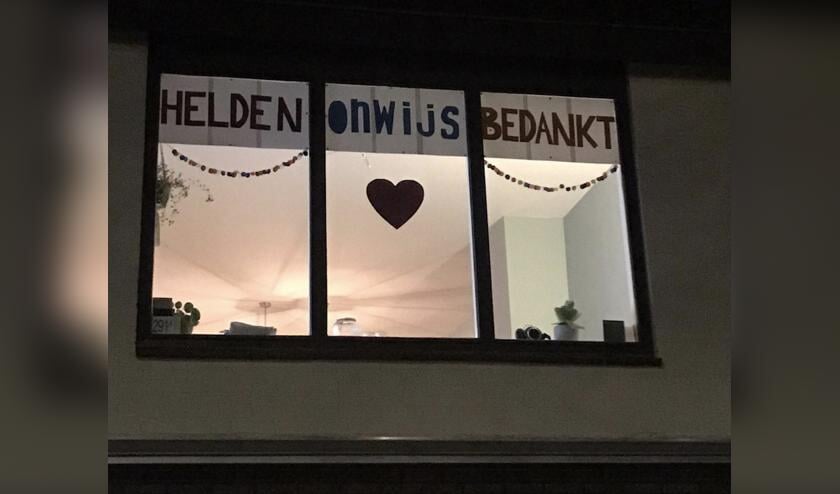 Met het spandoek wil het drietal alle mensen met vitale beroepen bedanken.