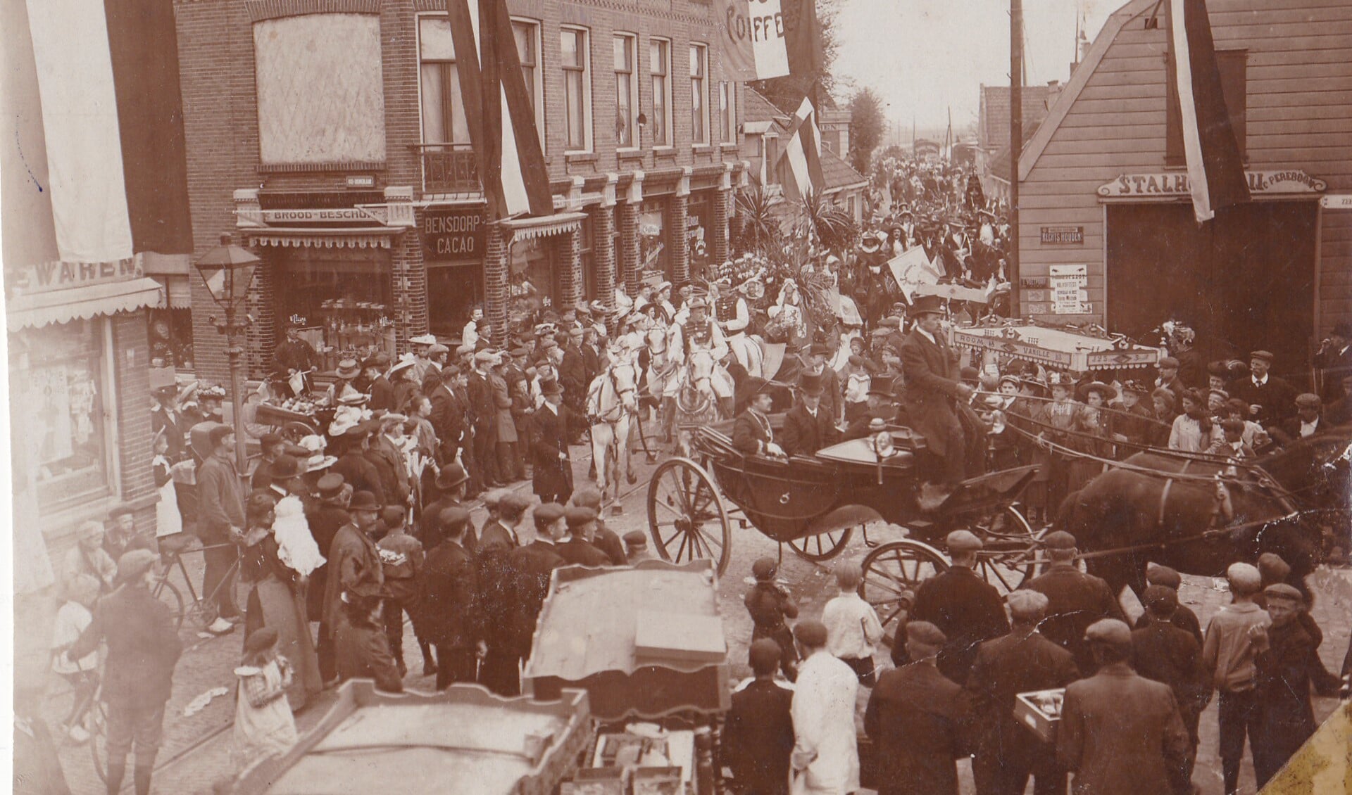 Optocht ter gelegenheid van de geboorte van prinses Juliana op 30 april 1909. De stoet gaat richting de Diemer ophaalbrug, naar de Ouderkerkerlaan. Aan de linkerzijde – in het verlengde van de brug - is de Ouddiemerlaan. In het open rijtuig het college van burgemeester jhr. E.W.E. Bicker en zijn wethouders.