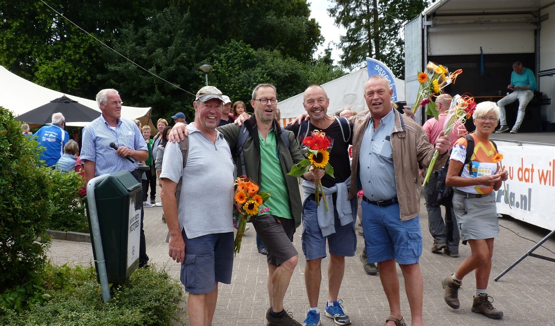 Cock (r) verwelkomt zijn broers Jan, Arnold en Gerard Smit met fleurige boeketten.