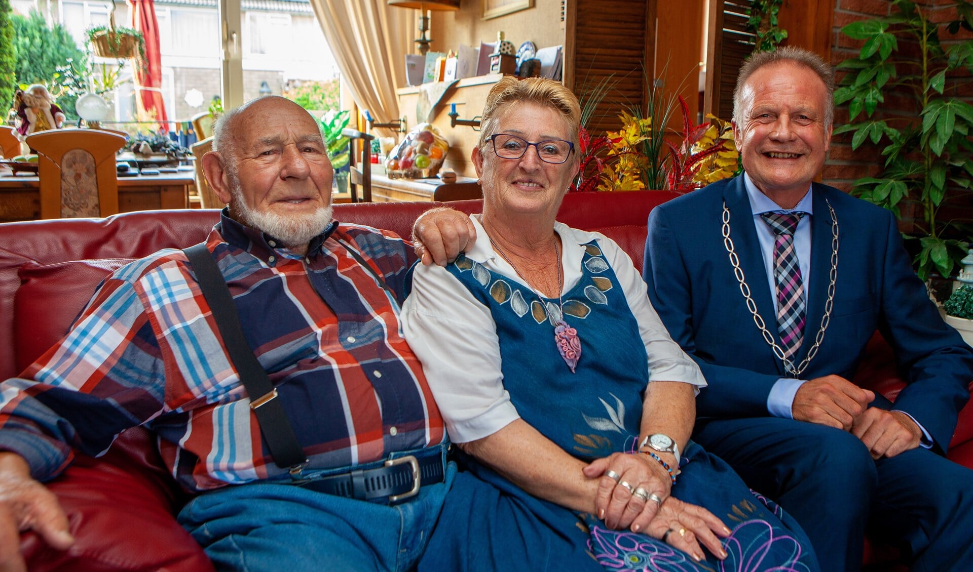 Joop en Ans samen met de burgemeester op de bank.