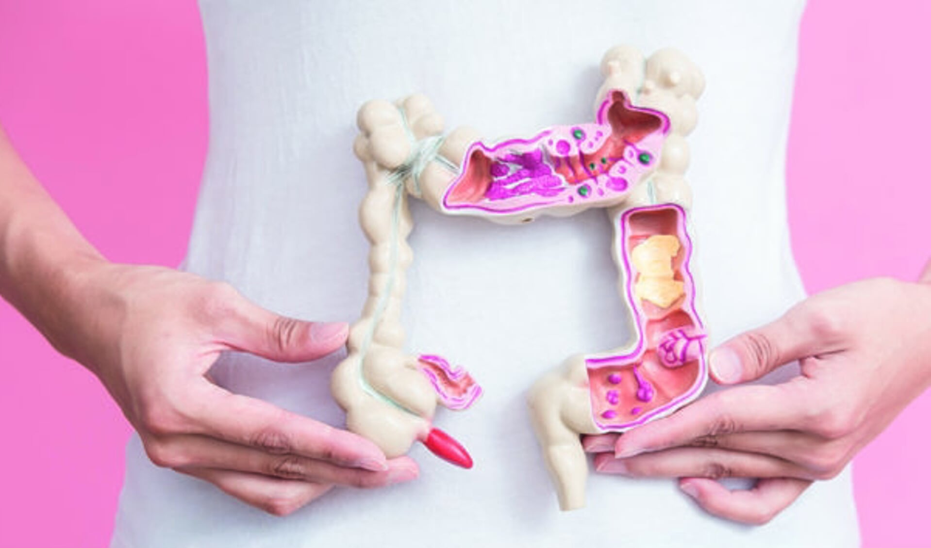 woman with colorectal cancer concept on the pink backgorund