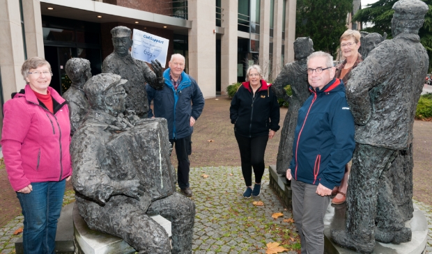 <p>Het bestuur van de Klepperman van Elleven met de cheque bij de beeldengroep van de klepperman voor het oude Rabogebouw.</p>
