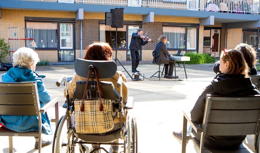 Op veilige afstand konden bewoners en verzorgenden van De Bolder van muziek genieten.