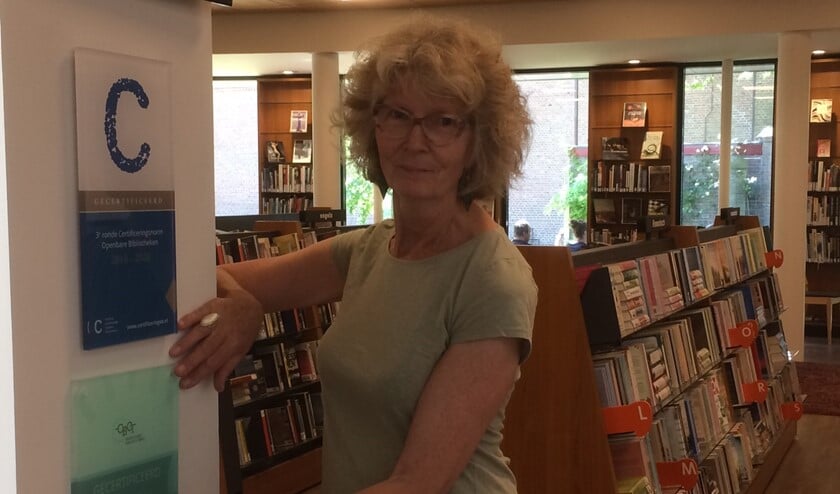Medewerkster Saskia Plomp plaatst het nieuwe certificeringsbord in de vestiging in Laren.