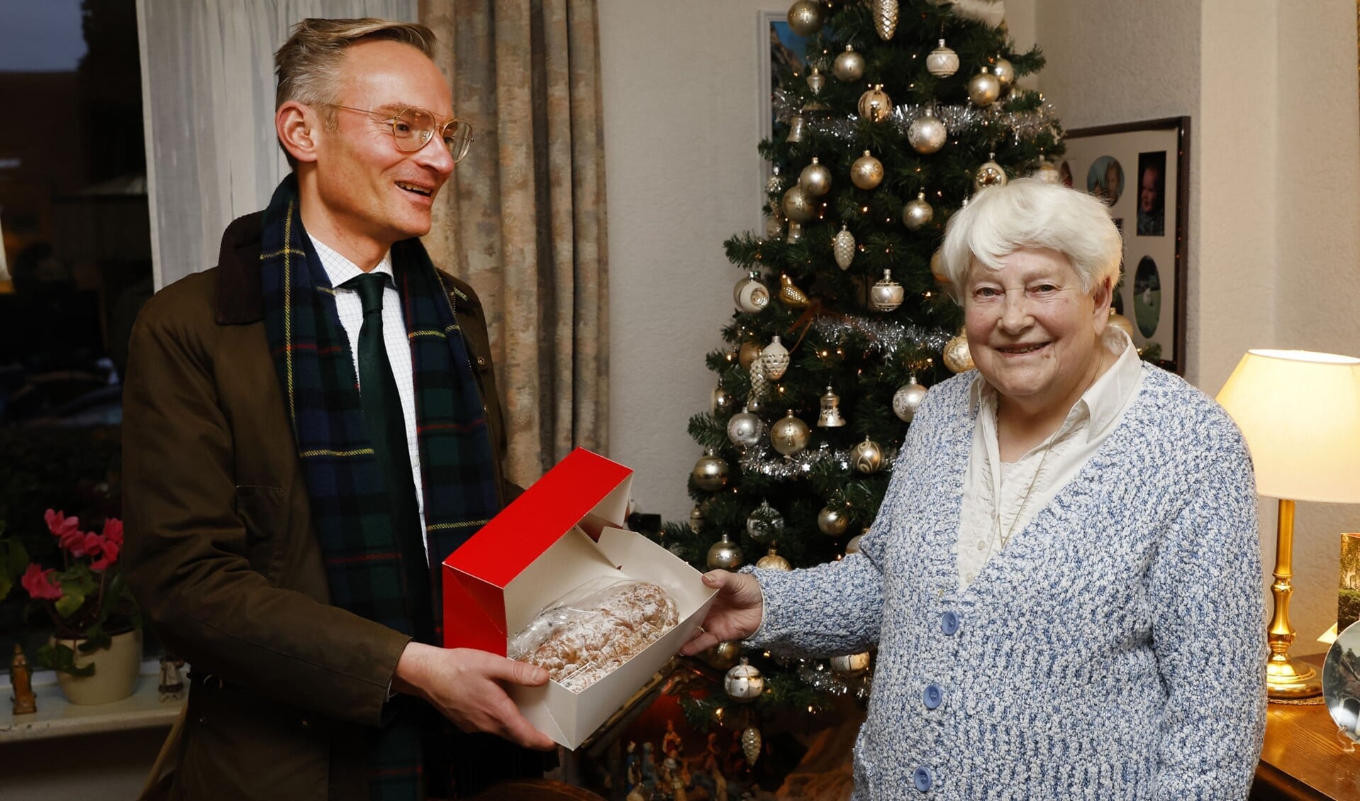 Burgemeester Nanning Mol overhandigde de eerste kerststol aan mevrouw Hom.