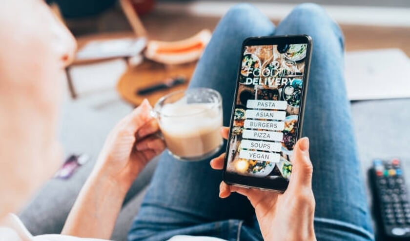 Woman ordering food online on her electronic device