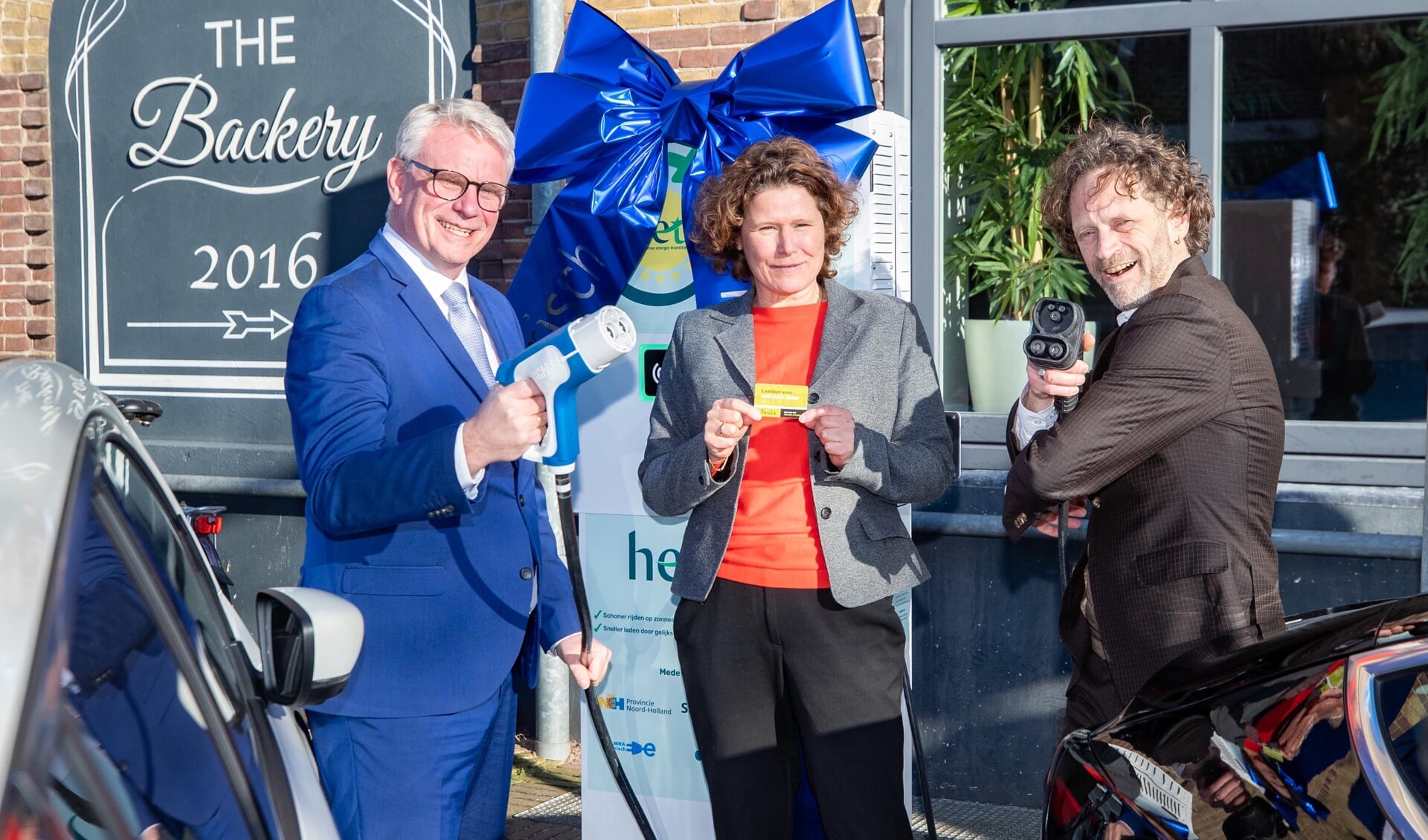 Gedeputeerde Jeroen Olthof en wethouders Annette Wolthers en Bart Heller openen de unieke laadpaal in Hilversum.