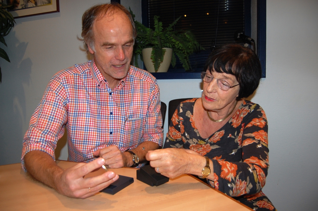 Hans en Betty Burggraaff bewonderen elkaars onderscheidingen.