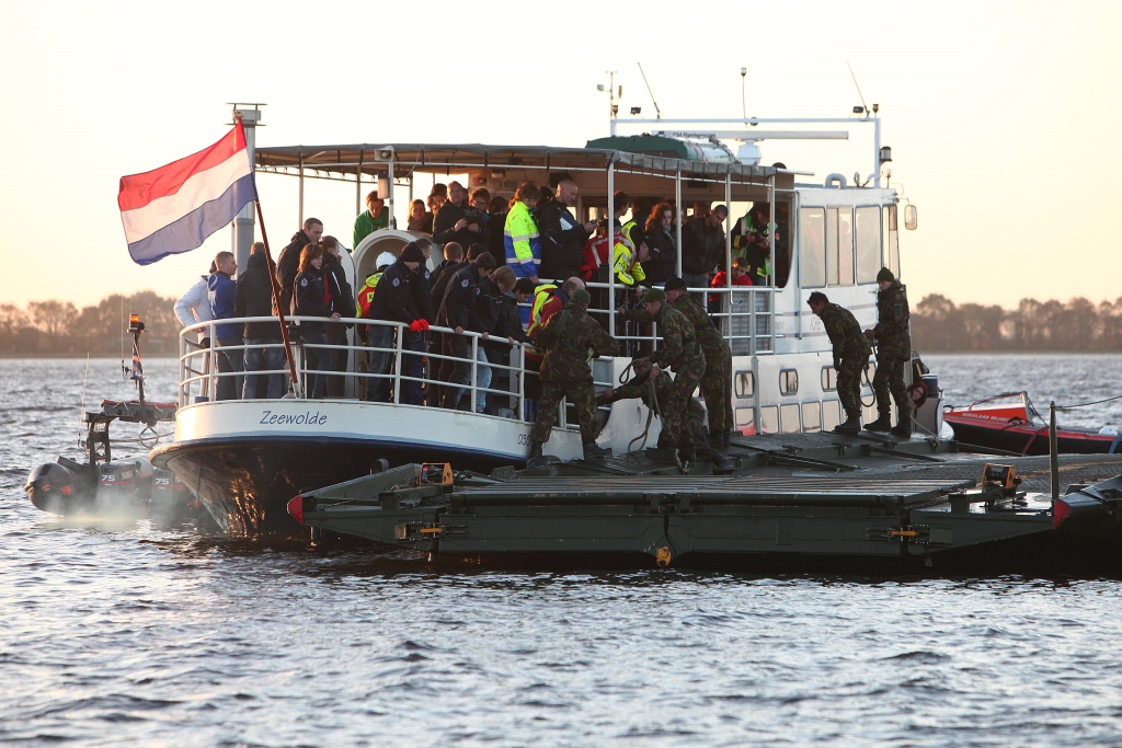 Partyboot Achie uit Zeewolde met 90 partygangers aan boord krijgt een drijvend brugponton naast zich van de 43 Gemechaniseerde Brigade.