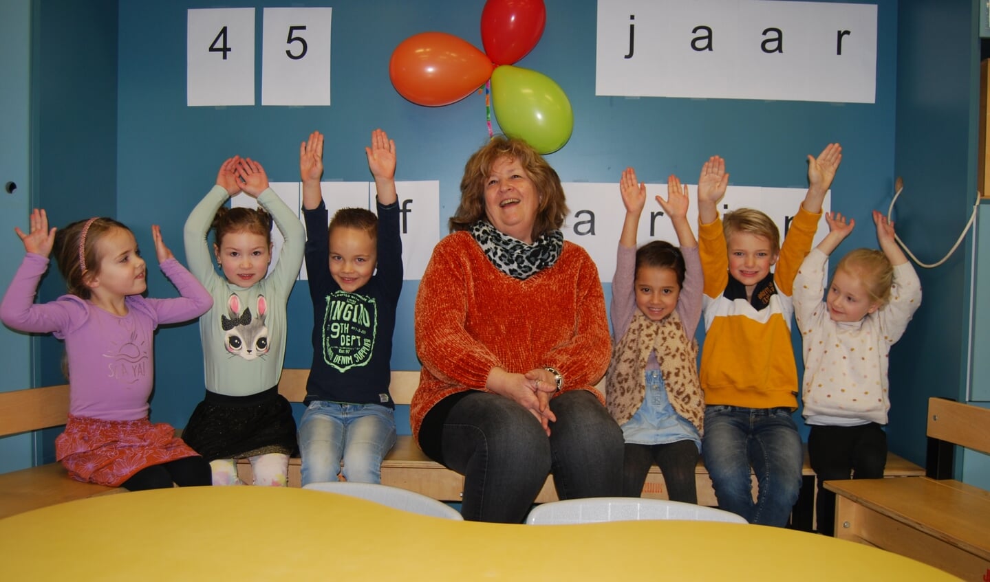 Juf Karin in de klas met een paar van 'haar' kleuters.