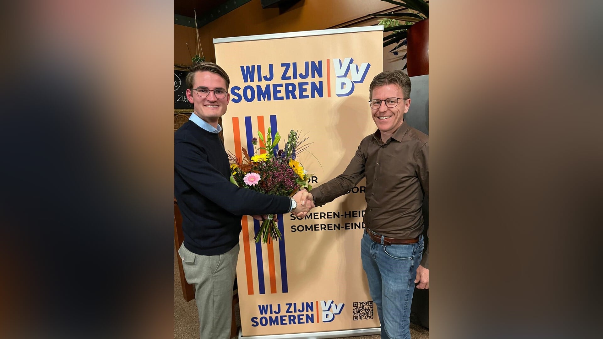 Koert Kusters (r), de nieuwe lijsttrekker, ontvangt felicitaties namens het bestuur (l).