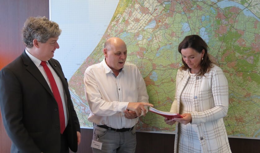 Onder toeziend oog van gemeenteraadslid Christiaan van Nispen tot Sevenaer overhandigt Herman Kramer de handtekeningen aan gedeputeerde Jacqueline Verbeek.  