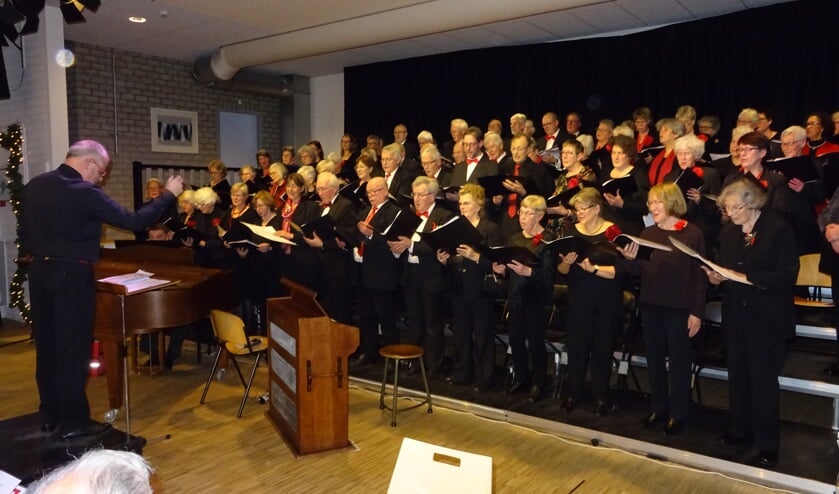 Een goed gevulde zaal geniet van de vocale prestaties van beide koren.
